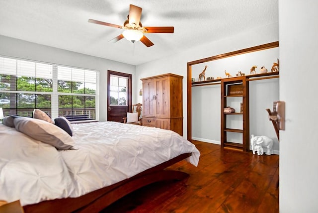 bedroom featuring baseboards, a ceiling fan, and hardwood / wood-style floors