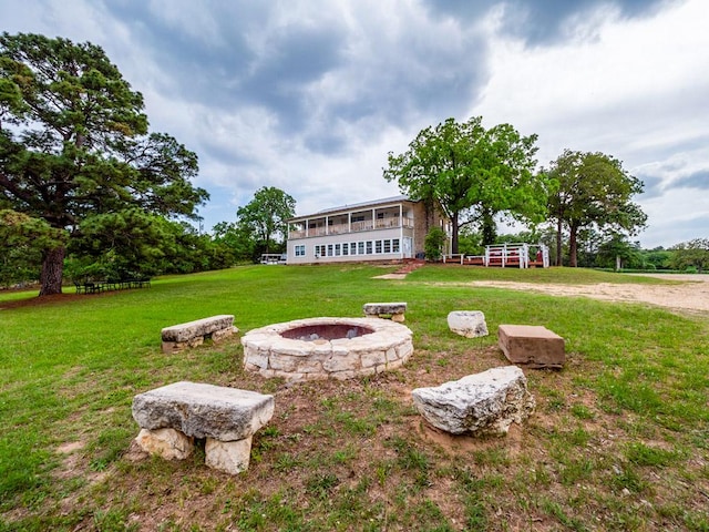 view of yard with a fire pit