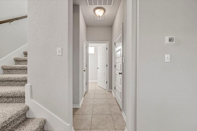 2208 Pecan Island Dr, Leander, TX 78641 - hallway featuring light tile patterned floors and stairway
