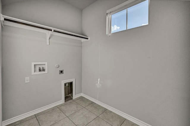 clothes washing area with laundry area, light tile patterned flooring, baseboards, hookup for a washing machine, and hookup for an electric dryer
