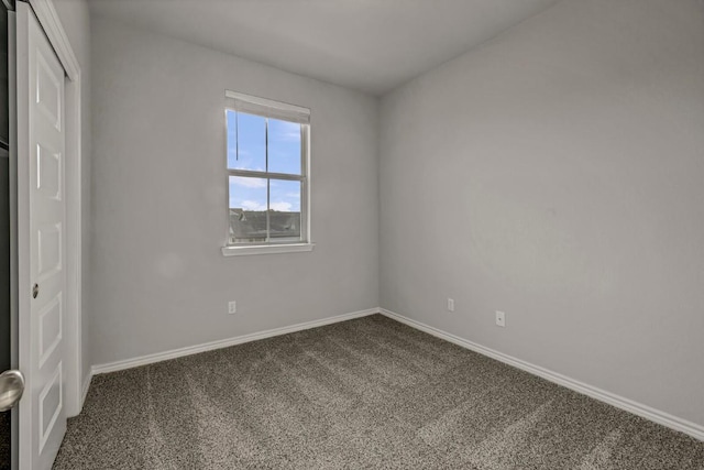 unfurnished bedroom with carpet floors and baseboards