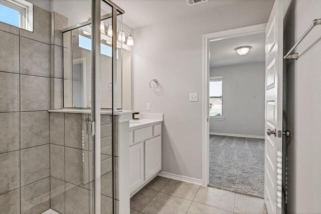 2208 Pecan Island Dr, Leander, TX 78641 - bathroom featuring vanity, a stall shower, and tile patterned floors