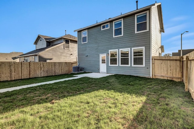 back of house featuring a fenced backyard and a yard