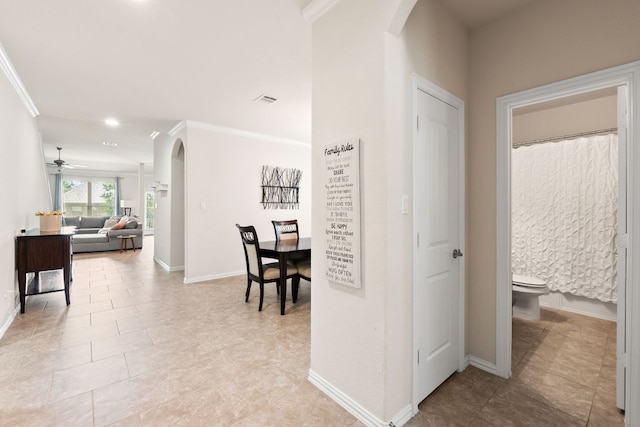 4018 Geary St, Round Rock, TX 78681 - hallway with arched walkways, ornamental molding, baseboards, light tile patterned floors, and recessed lighting