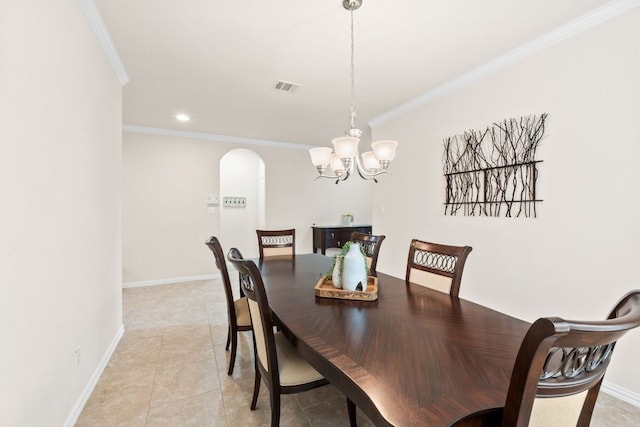 dining space with crown molding, visible vents, an inviting chandelier, baseboards, and arched walkways