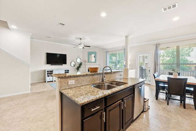 kitchen with a sink, a ceiling fan, open floor plan, stainless steel dishwasher, and visible vents