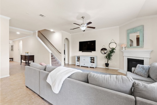 4018 Geary St, Round Rock, TX 78681 - living area featuring arched walkways, stairs, a ceiling fan, ornamental molding, and a glass covered fireplace