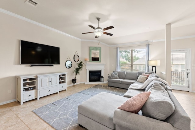 4018 Geary St, Round Rock, TX 78681 - living area featuring a ceiling fan, light tile patterned floors, ornamental molding, baseboards, and a glass covered fireplace