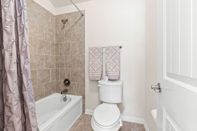full bath with baseboards, tile patterned flooring, toilet, and shower / tub combo