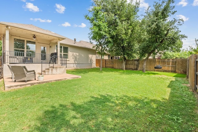 view of yard featuring a patio, ceiling fan, and a fenced backyard