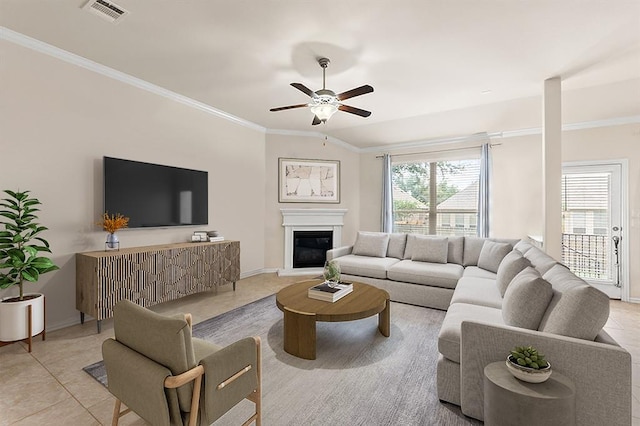 4018 Geary St, Round Rock, TX 78681 - living area featuring crown molding, ceiling fan, a glass covered fireplace, and light tile patterned floors