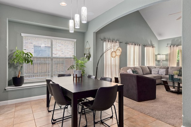 dining room featuring baseboards, recessed lighting, arched walkways, light tile patterned floors, and vaulted ceiling