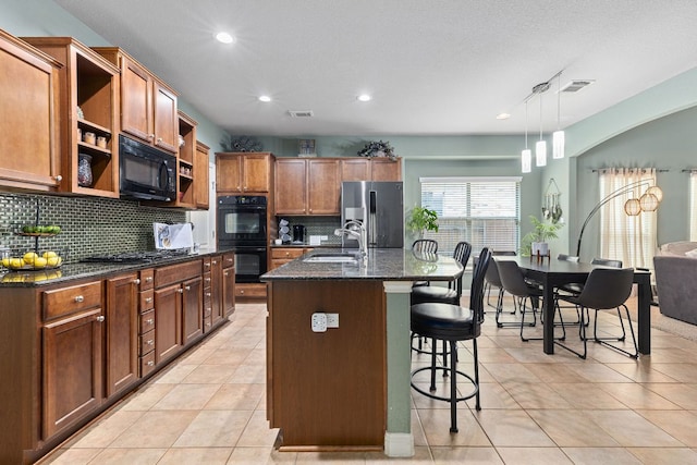 kitchen with open shelves, a kitchen bar, tasteful backsplash, a sink, and black appliances