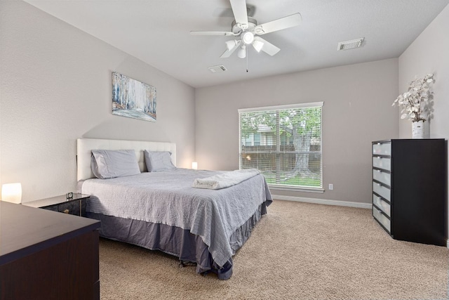 bedroom with visible vents, carpet flooring, baseboards, and ceiling fan
