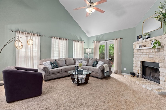 carpeted living area with baseboards, ceiling fan, high vaulted ceiling, and a fireplace