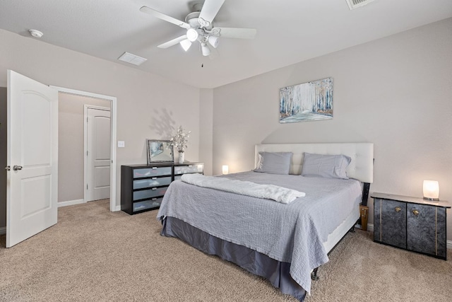 carpeted bedroom with visible vents, a ceiling fan, and baseboards