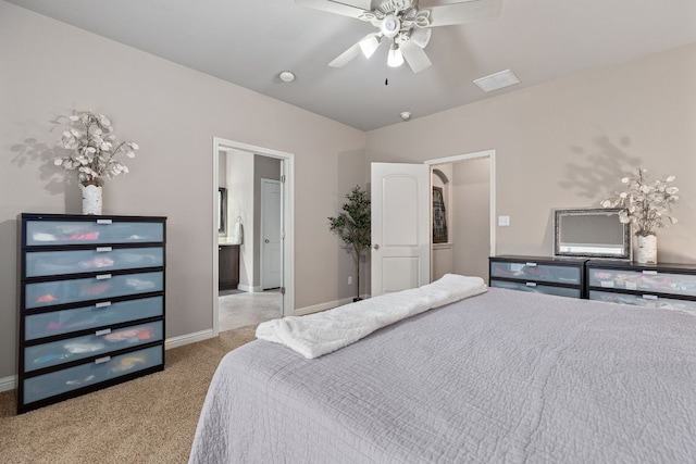 carpeted bedroom featuring baseboards, a ceiling fan, and visible vents