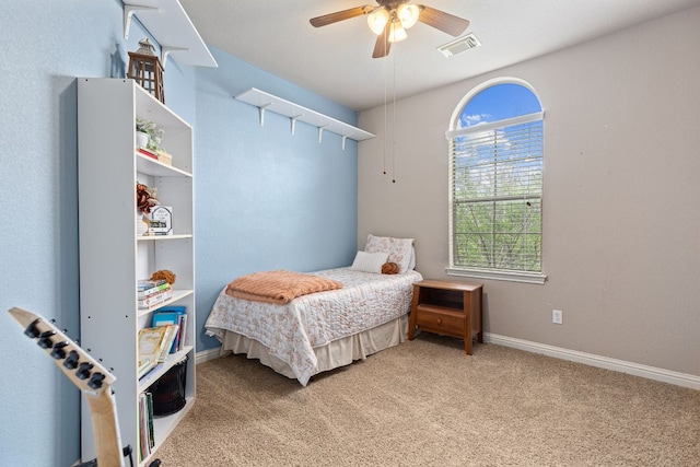 carpeted bedroom with baseboards, ceiling fan, and visible vents