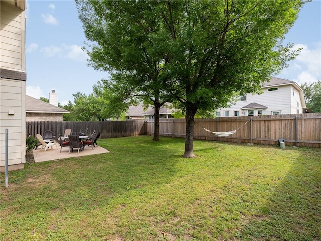 view of yard with a fenced backyard and a patio