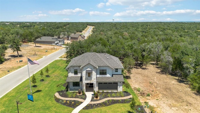 birds eye view of property featuring a wooded view