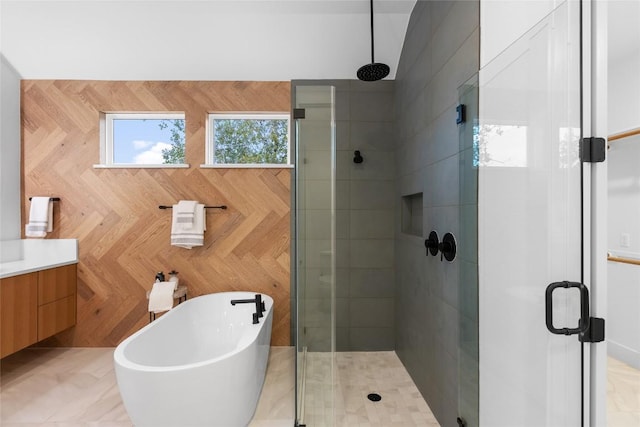 full bathroom with vanity, a freestanding tub, and a stall shower