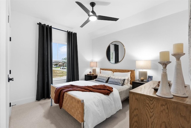 carpeted bedroom featuring baseboards and ceiling fan