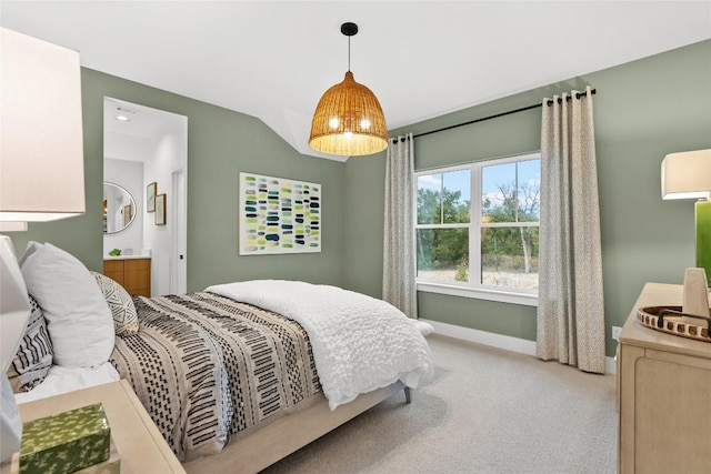 bedroom featuring baseboards, carpet flooring, and ensuite bath