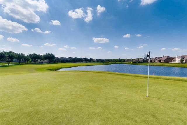 view of community with a water view, view of golf course, and a residential view