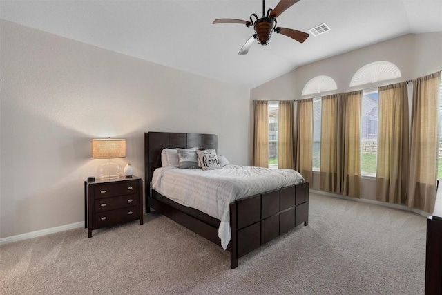 bedroom with lofted ceiling, light carpet, baseboards, and ceiling fan