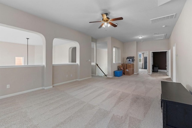 spare room featuring carpet flooring, ceiling fan, and baseboards