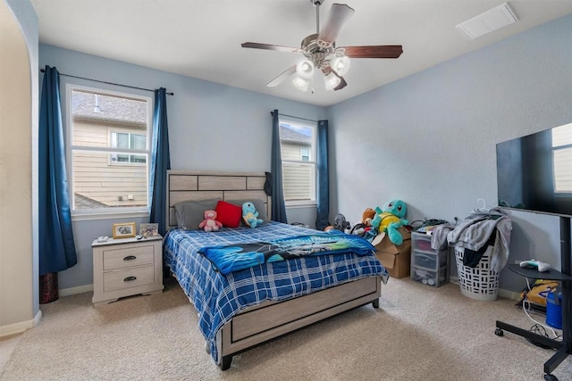 carpeted bedroom featuring baseboards and ceiling fan