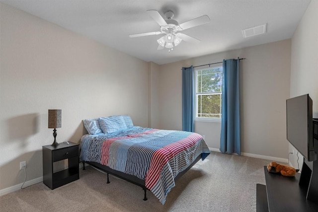 bedroom featuring light colored carpet, baseboards, and a ceiling fan