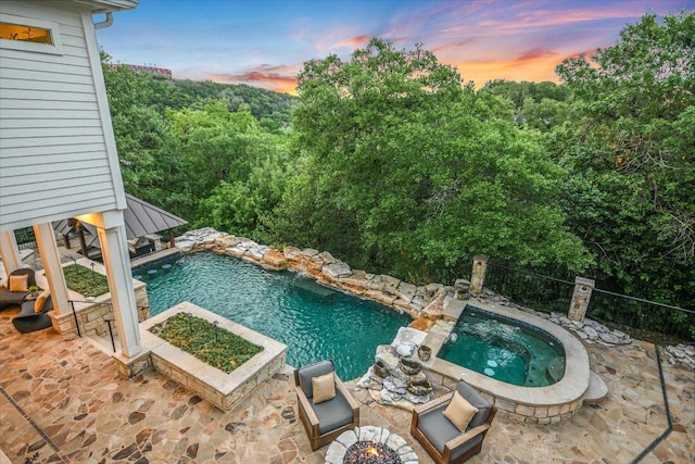 view of swimming pool with a patio, an in ground hot tub, and a fenced in pool