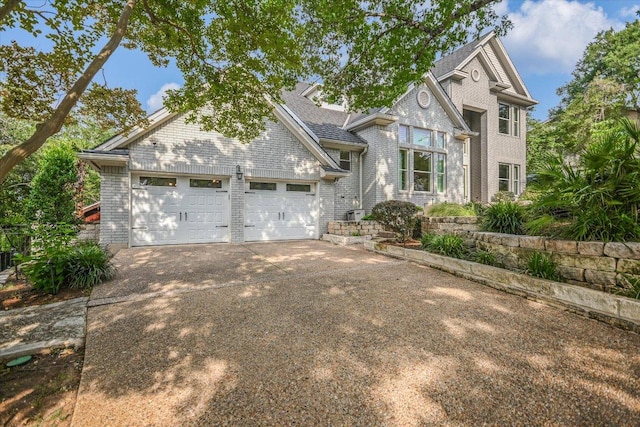 view of front facade with brick siding and concrete driveway