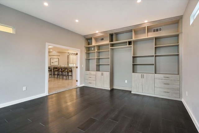 unfurnished living room featuring recessed lighting, baseboards, dark wood finished floors, and visible vents