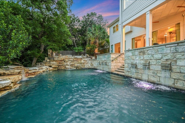 view of pool with a fenced in pool, fence, and stairs