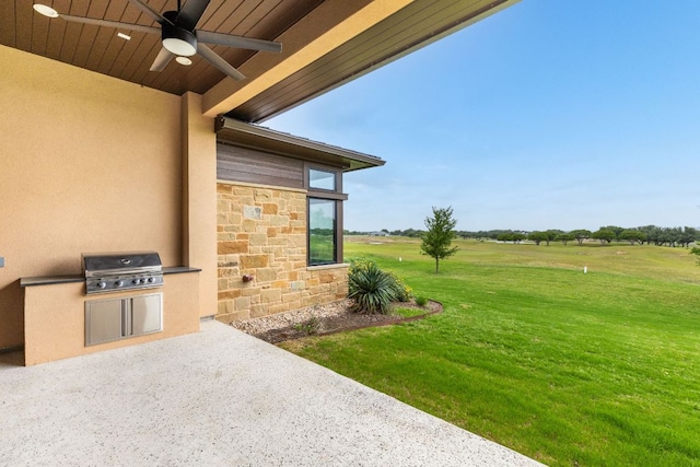 2317 Kahala Sunset Dr, Spicewood, TX 78669 - view of patio with an outdoor kitchen, a ceiling fan, and a grill