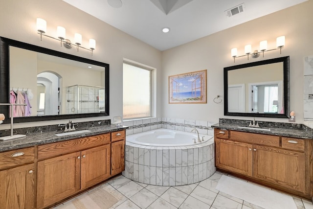 full bathroom featuring a bath, visible vents, a sink, and marble finish floor