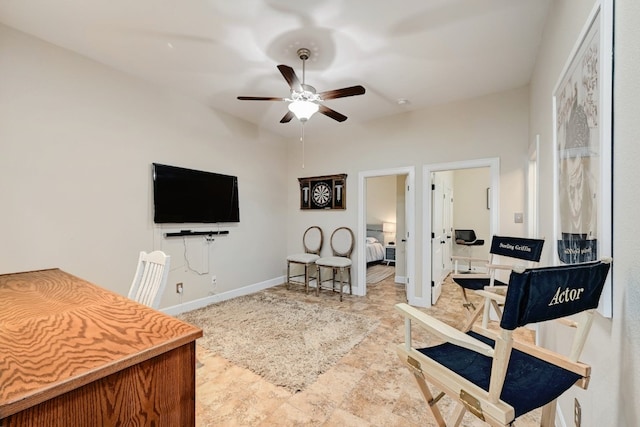 interior space featuring a ceiling fan and baseboards