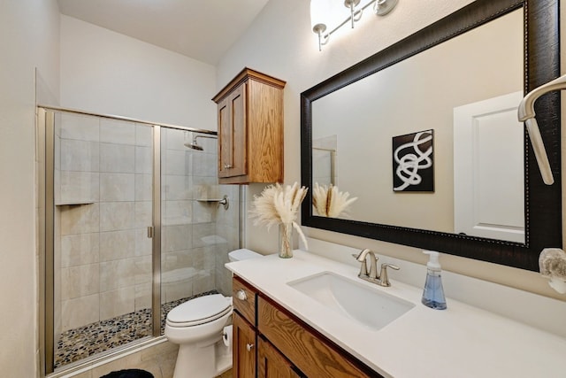 full bath featuring vanity, toilet, tile patterned floors, and a stall shower