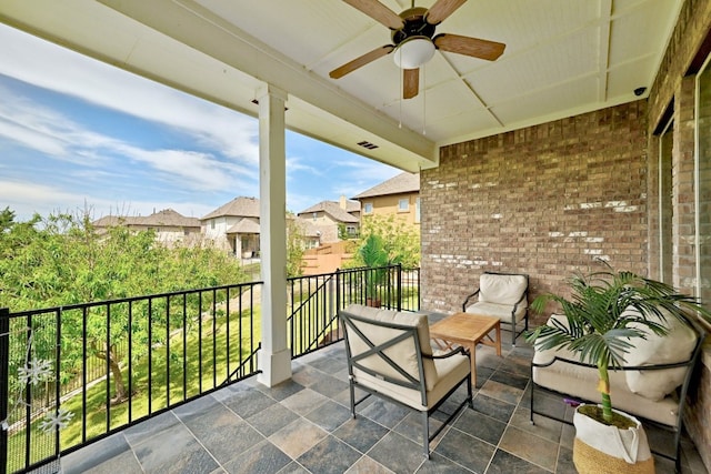 balcony with a residential view, a ceiling fan, and visible vents