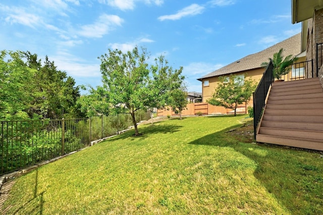 view of yard with stairway and a fenced backyard
