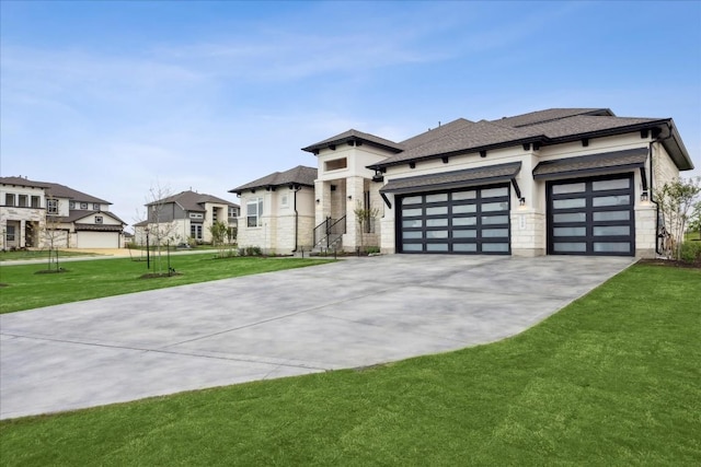 prairie-style house featuring a residential view, a front lawn, stone siding, a garage, and driveway