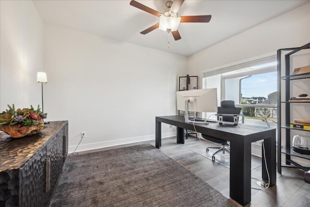 office area with a ceiling fan, baseboards, and wood finished floors
