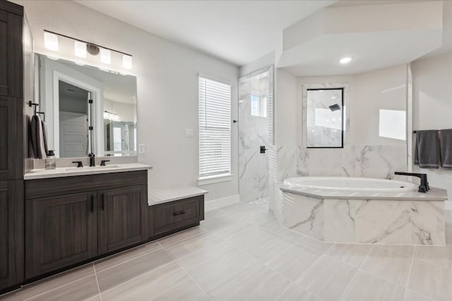 full bath featuring a garden tub, vanity, baseboards, tile patterned floors, and a marble finish shower