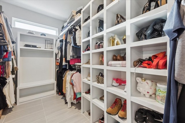 spacious closet with tile patterned floors