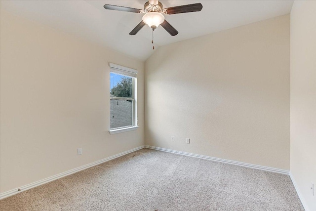 carpeted empty room with baseboards, ceiling fan, and vaulted ceiling