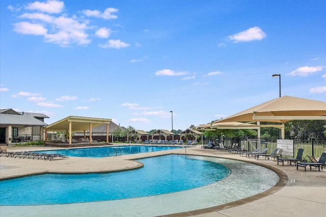 pool featuring a patio area and fence