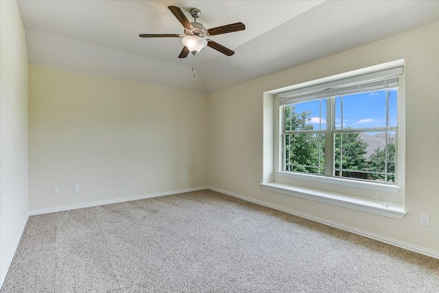 empty room featuring ceiling fan, baseboards, and carpet