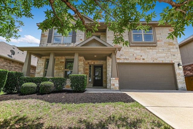 3639 Hermann St, Round Rock, TX 78681 - view of front of property featuring a garage, covered porch, driveway, and stone siding